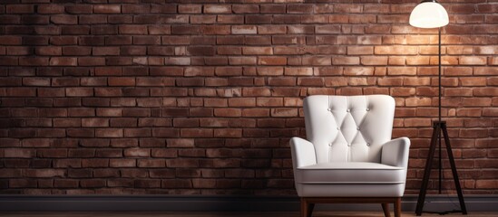 A white chair placed in front of a textured brick wall, complemented by the soft glow of a lamp