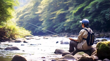 渓流で釣りをする日本人男性、川と自然の風景