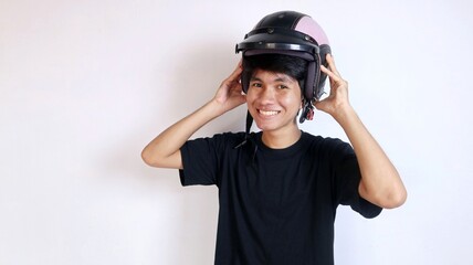Young Asian man gesturing using a helmet