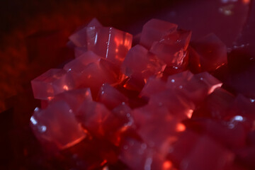 pile full of red jelly cut into cubes, food background
