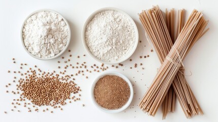 Top view of gluten-free ingredients with bowls of buckwheat flour, whole grains, and a bundle of soba noodles on a white surface, hinting at healthy cooking