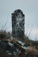 A tombstone on a hill --ar 2:3 Job ID: d392feb0-1e83-4f60-b5ed-3a589e63b4e9