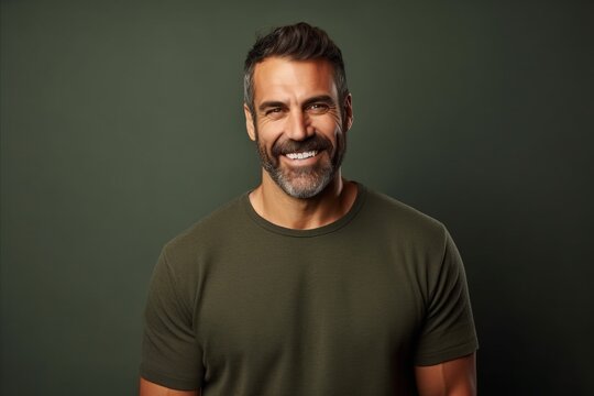 Portrait of a handsome mature man in a green t-shirt.