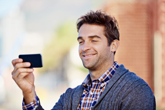 Photograph, outdoor and man with smartphone, smile and memory with social media and connection. Person, guy in a city and mobile user taking a picture and cellphone with digital app and technology