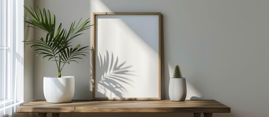 Minimalistic room interior showcasing a mock up photo frame on a brown wooden table with a beautiful plant in a hipster white pot, against grey walls. The concept is stylish and floral,