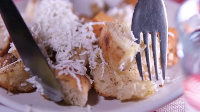 Cheese bread grated cheese on top of a soft white loaf. Macedonian traditional food Eat with a fork and knife stick the fork into the fresh spoiled dough