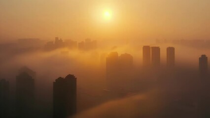 The hazy outline of a city skyline obscured by dense fog with the sun peeking through in the background.