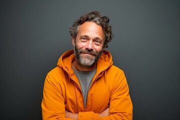Portrait of a middle-aged man in an orange jacket.