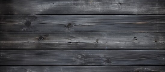 Obraz na płótnie Canvas A detailed view of a wooden wall set against a dark background