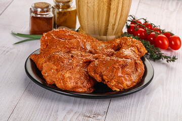 Raw turkey shoulder wing in Indian tandoori marinade
