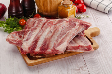 Raw pork ribs over board