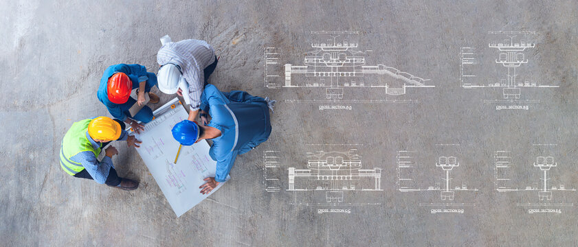 Electric Train Section drawing for construction, top view of architectural engineer working on his blueprints with documents on construction site. meeting, discussing,designing, planing
