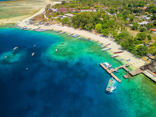 Boats surrounding a coral reef and small tropical island