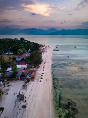 Aerial view of a beach resort on a small tropical island at sunset (Gili Air, Indonesia)