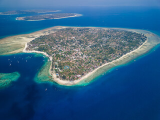 Aerial view of the harbor, port and boats of the tiny tourist island of Gili Air off the island of...