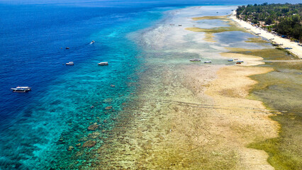 Traditional outrigger boats on the tropical coral reef off Gili Air near Lombok, Indonesia