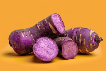Pile of Purple Sweet Potatoes on Yellow Background