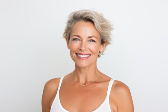 Portrait of a smiling mature woman with short hair on white background