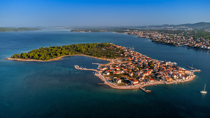 Krapanj, Croatia - Aerial panoramic view of Krapanj island (Otok Krapanj), the smallest inhabited island in Croatia. Yachts, red rooftops and clear blue sky on sunny summer morning by the Adriatic sea