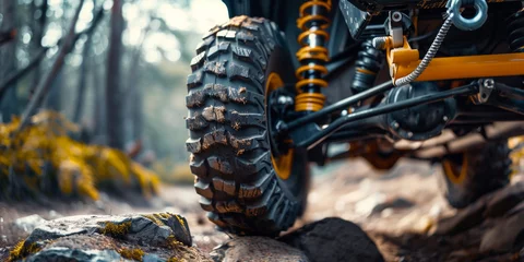 Poster Close-up view of quad bike rear wheel on rocky road © kanurism