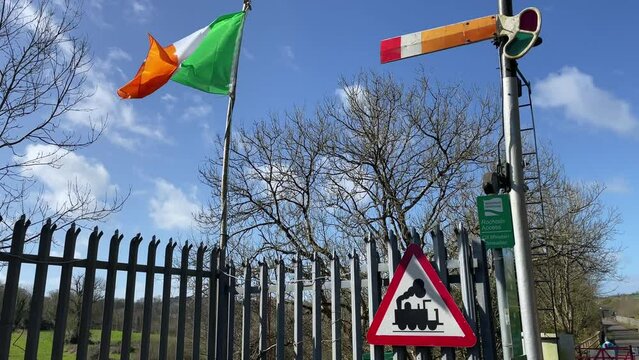 Irish flag old railway signal and train sign and blue sky Kilmeaden Station Waterford Ireland