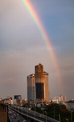 Naklejka na ściany i meble rainbow over skyscrapers in Bangkok