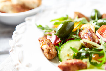 Healthy Salad with Chicken Breast, Cherry Tomatoes, Cucumber, Rocket and Green Olives. Close up.	