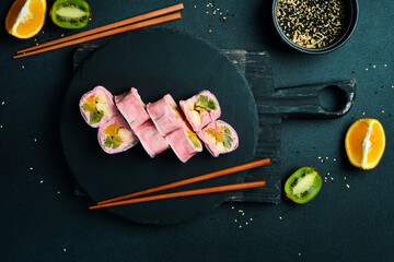 Japanese sushi rolls with fruit and yogurt. Sweet dessert.