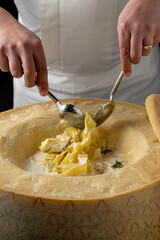 Fresh pasta with sauce in a whole parmesan wheel