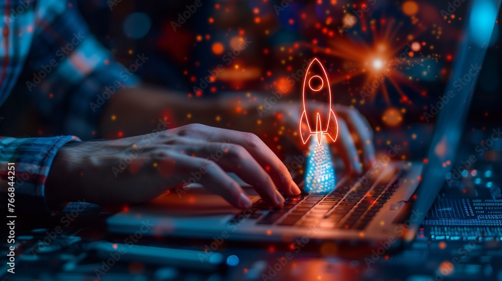 Poster a person is typing on a laptop with a rocket on the screen. the rocket is lit up in red and blue, an