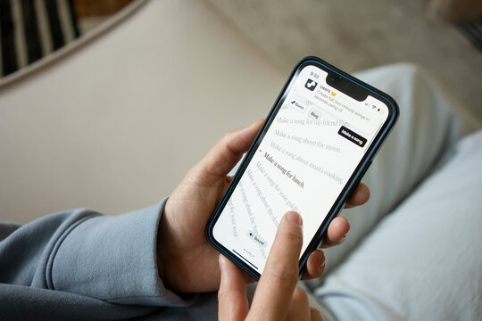 Portland, OR, USA - Mar 24, 2024: An iPhone user tries to make a song by herself with the assistance of Suno, the AI song generator, on the website of Suno AI, a startup creating a ChatGPT for music.