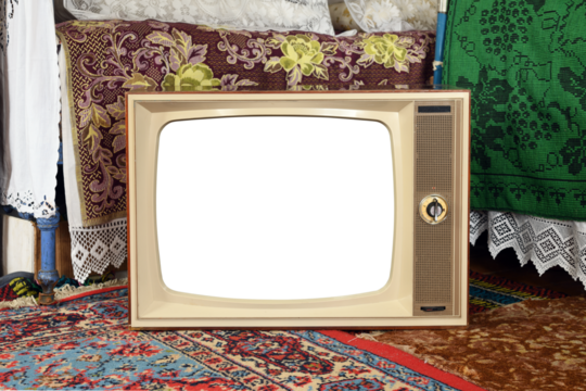 An old vintage TV with a white screen in a rustic interior.