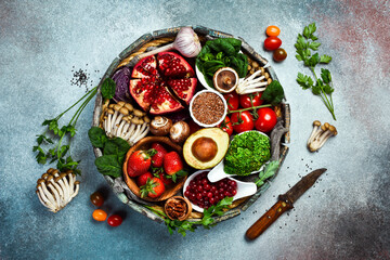 A set of vegetables, fruits, berries and nuts, mushrooms and superfoods in a wooden round box. Top view.