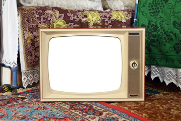 An old vintage TV with a white screen in a rustic interior.