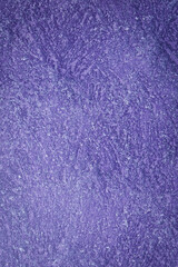 Violet textured surface, Venetian stucco for backgrounds. Top view.