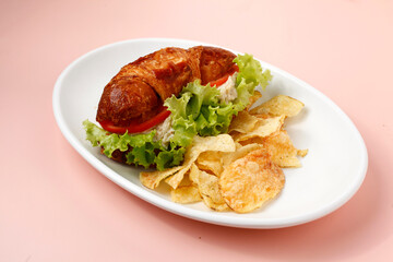 Freshly made croissant with tuna spread filling served with chips