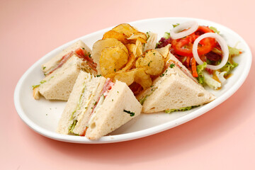 Freshly made clubhouse sandwich served with chips