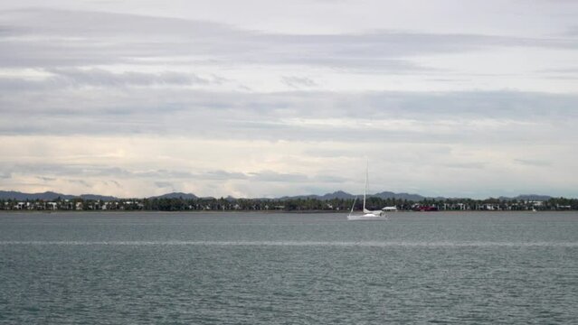 Boat ride Tourism Fiji Nada Suva Garden Island Coral Coast Taveuni follow sailboat morning mountain peaks tropical island palm coconut tree cloudy blue sky Pacific Ocean calm bay follow motion