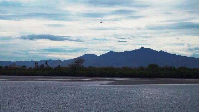 Boat ride follow helicopter flight Nausori Highlands Tourism Fiji Nada Suva Garden Island Coral Coast Taveuni morning mountain peaks tropical island palm coconut tree cloudy blue sky calm bay