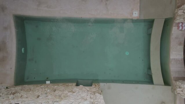 Rising Shot of Abandoned Dirty Courtyard Pool at Hotel