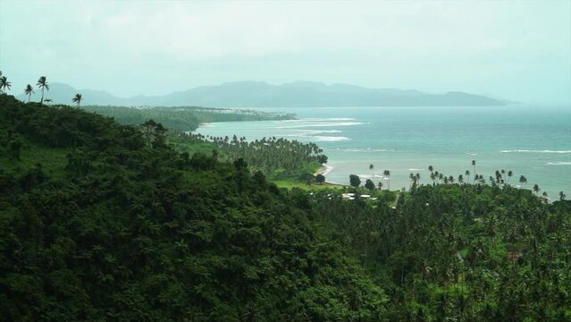 Tavarua Falls beach walk jungle Taveuni Garden Island coral coast reef break sand tropical peaceful waves crashing shoreline palm coconut trees sunny blue sky cloudy boulder clear water static shot