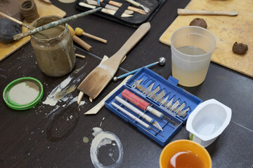 Tools for creativity on the table in a pottery workshop.