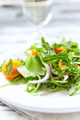 Salad with Tomatoes, Cucumber and Rocket on bright Background. Healthy Snack Idea. Close up.	