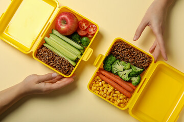 Yellow lunch box with buckwheat and fresh vegetables