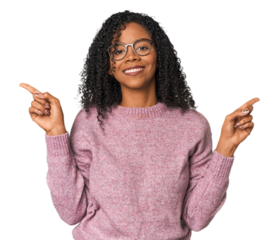 African American woman in studio setting pointing to different copy spaces, choosing one of them, showing with finger.