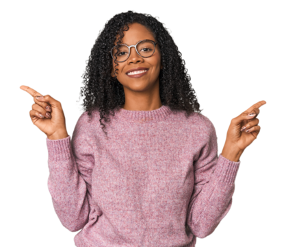 African American woman in studio setting pointing to different copy spaces, choosing one of them, showing with finger.