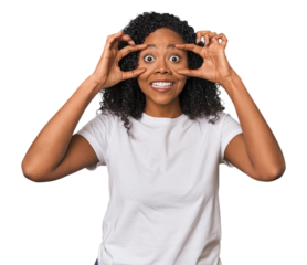 African American woman in studio setting keeping eyes opened to find a success opportunity.
