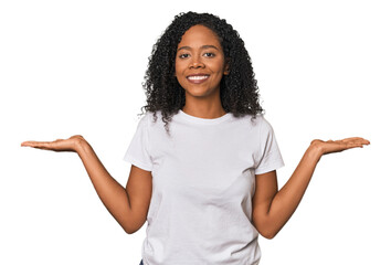 African American woman in studio setting makes scale with arms, feels happy and confident.