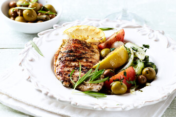 Grilled Turkey Breast with fresh salad. Bright background.	