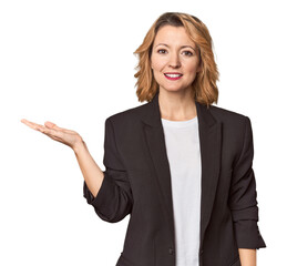 Caucasian woman in black business suit showing a copy space on a palm and holding another hand on...